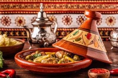 Traditional Moroccan chicken tagine with olives and salted lemons, selective focus.